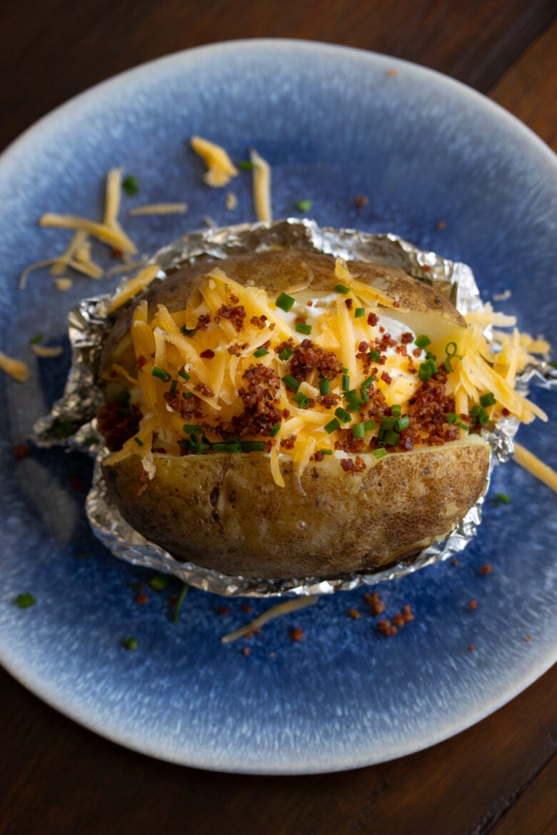 Oven Baked Potatoes loaded on a blue plate