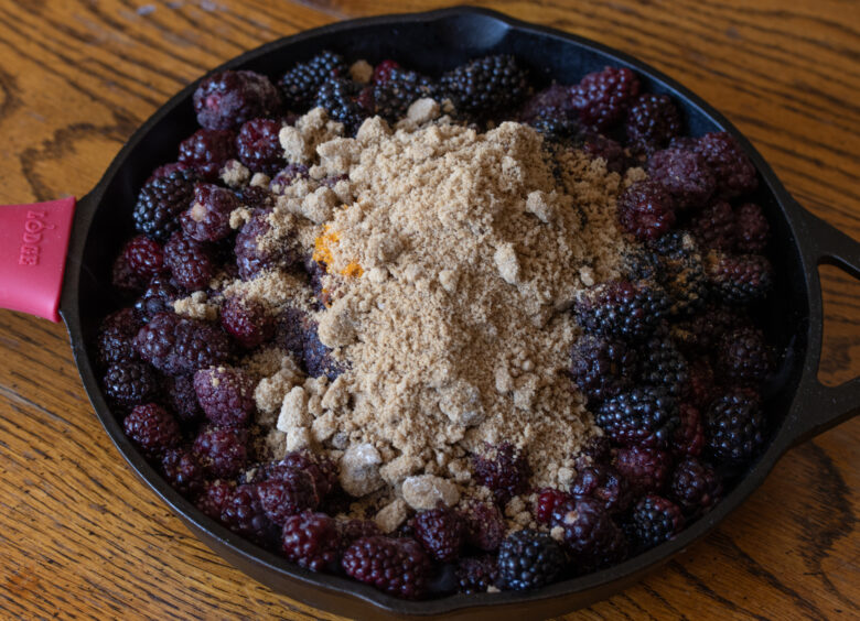 ingredients over the blackberries in a skillet