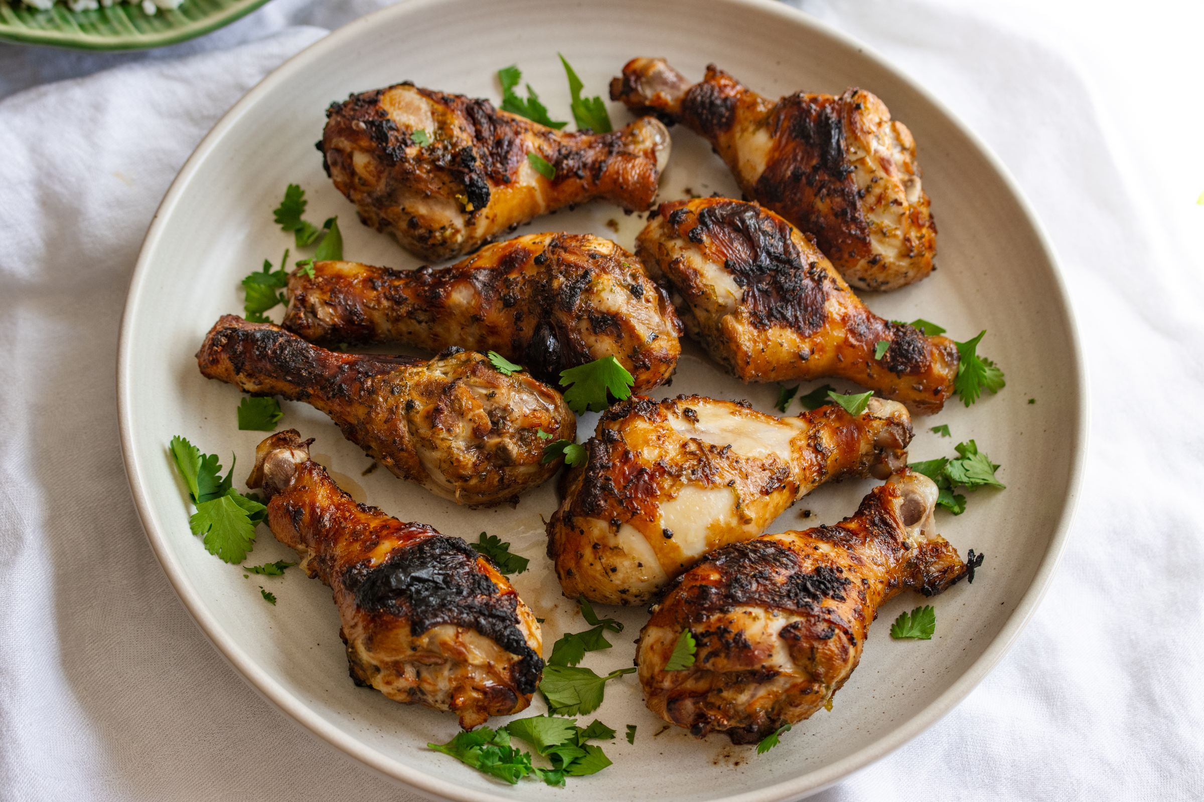 cilantro lime chicken drumstick on a white serving plate