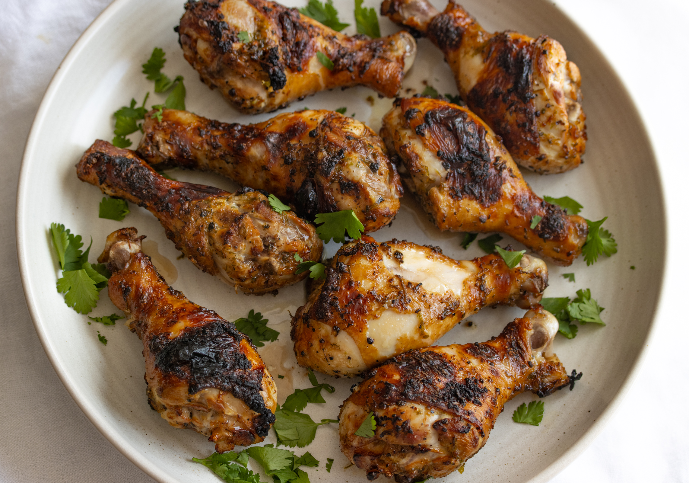 cilantro lime chicken drumstick on a white serving plate