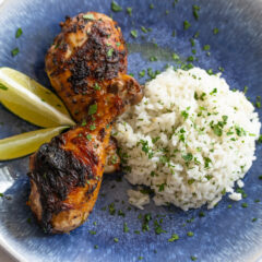 on a blue plate with rice and Cilantro Lime Chicken drumstick