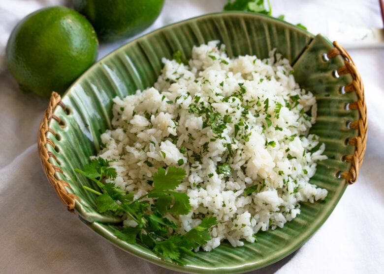 cilantro lime rice in a green serving ceramic dish