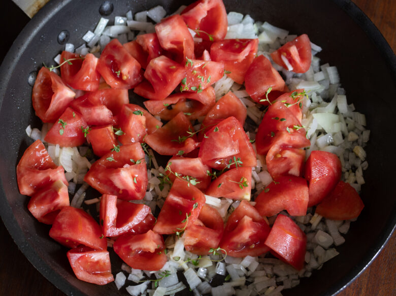 tomoates over garlic. and onion in a nonstick skillet