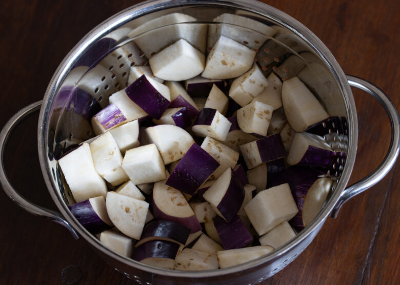 cut eggplant in a colander with salt