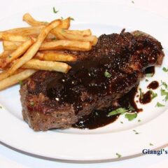 New York steak au poivre with balsamic reduction