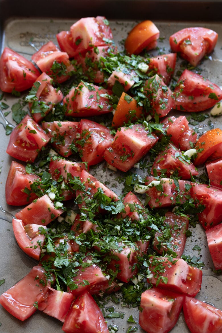 tomatoes on a cookie sheet ready to be roasted