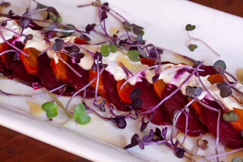 Roasted Beets with Horseradish Creme Fraiche on a white plate