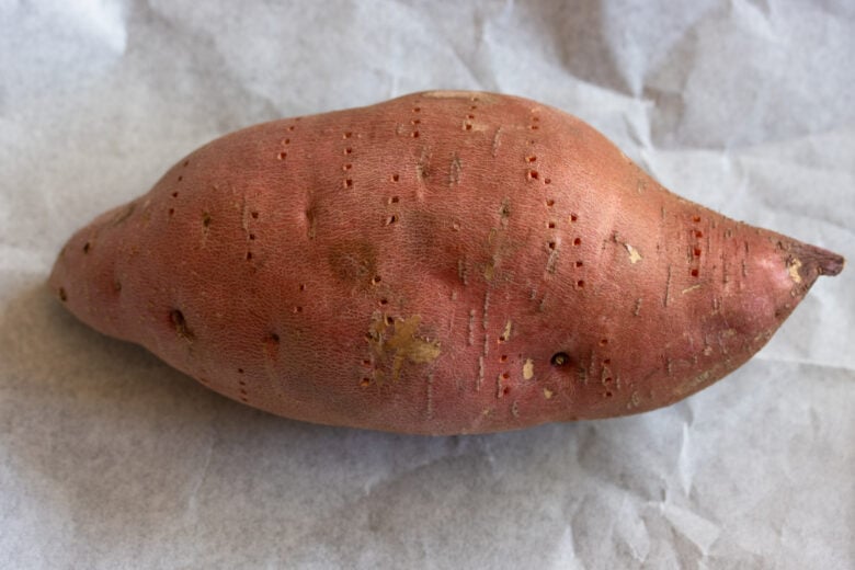 sweet potato poked with fork prior to baking