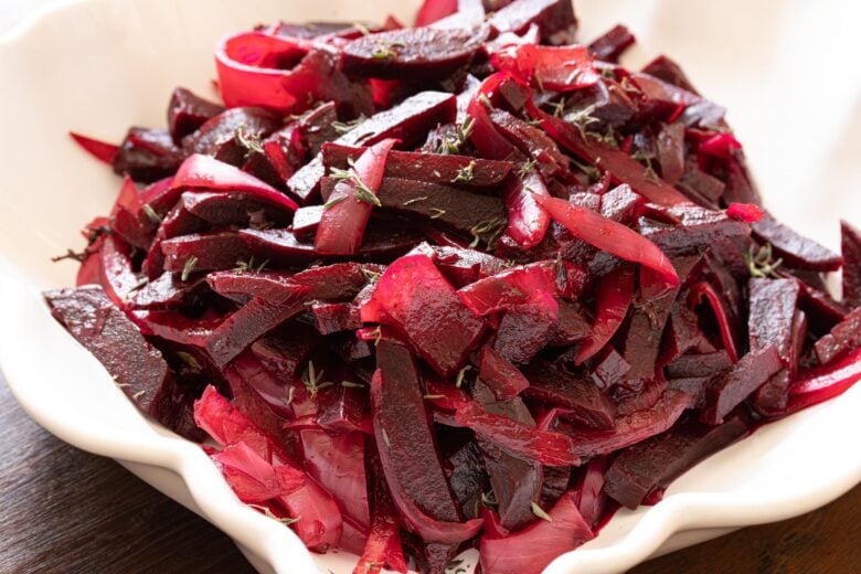 roasted beet and onion salad on a white serving dish