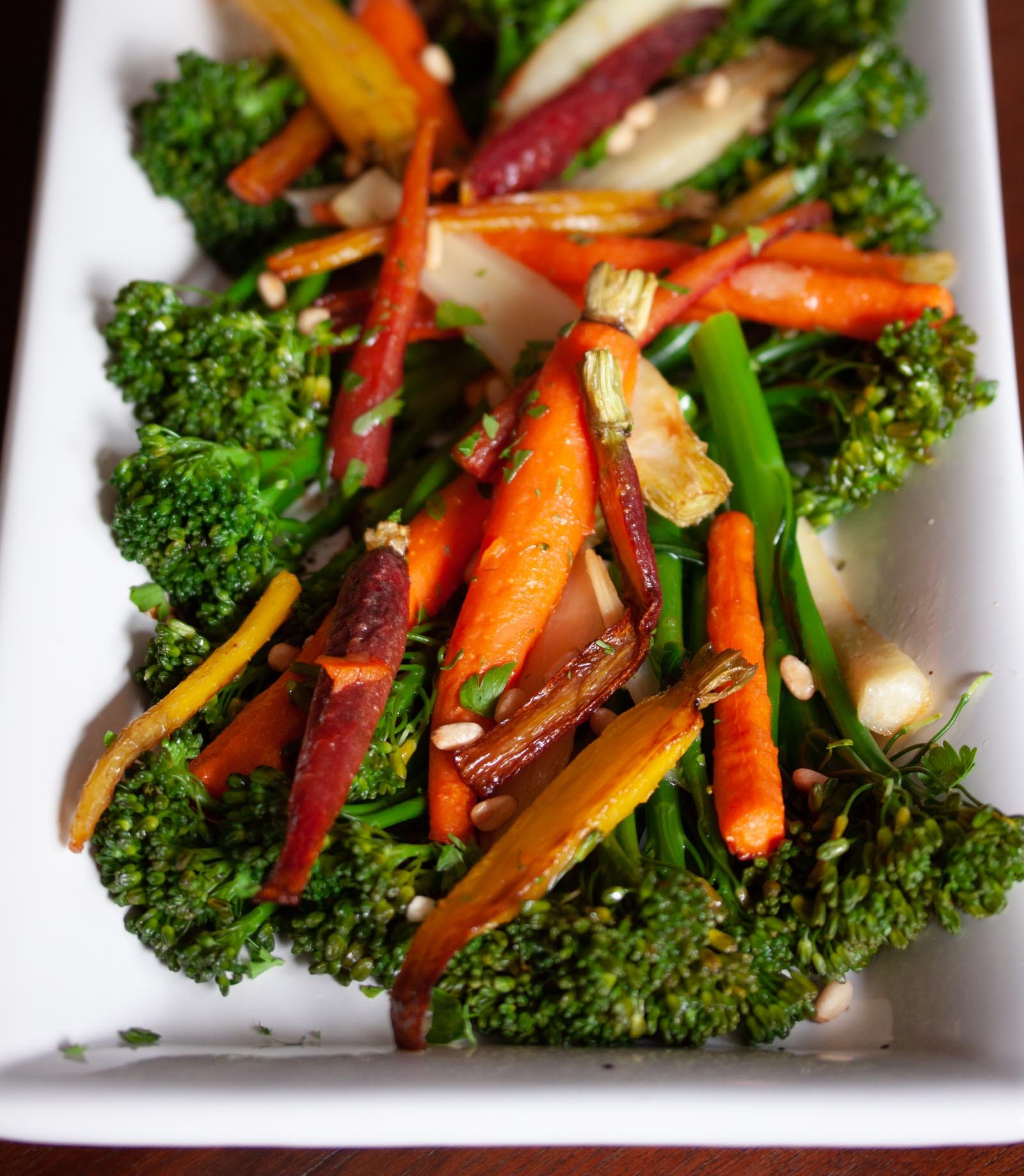 Rainbow Carrots with Broccolini on a white serving plate