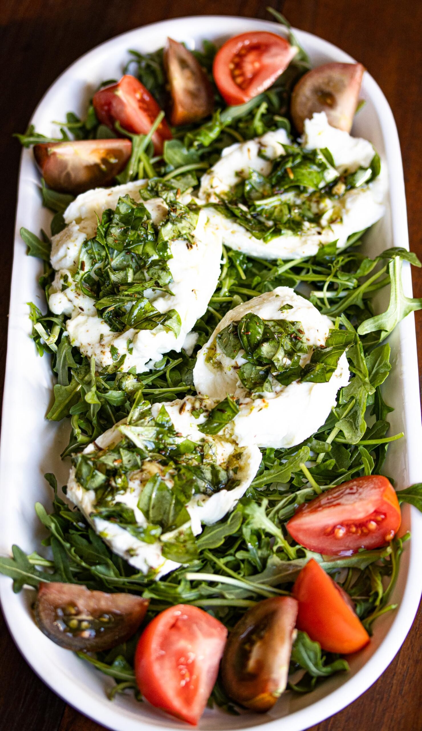 Buffalo mozzarella marinated, with tomatoes and arugula