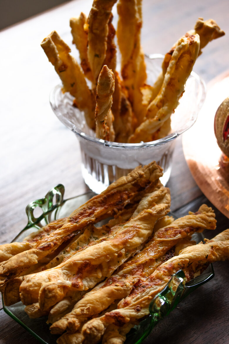 cheese breadsticks on a plate and in a glass for display