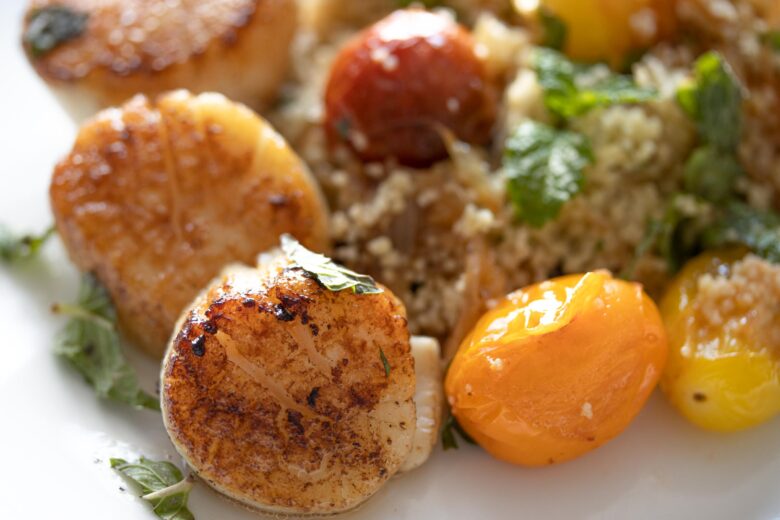 Couscous, Herbs, Tomatoes Salad with Scallops close up