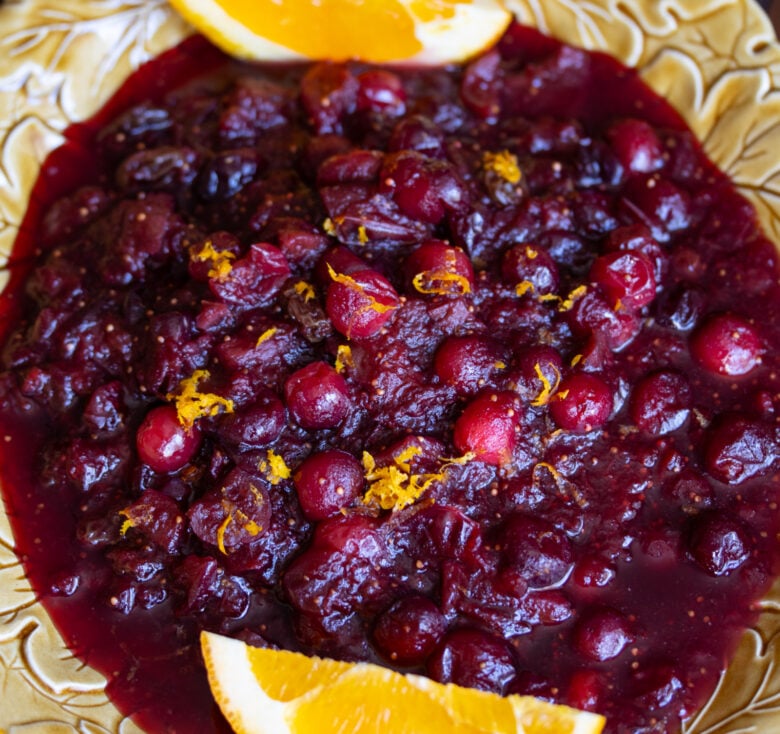 cranberry chutney with red wine and orange wedges