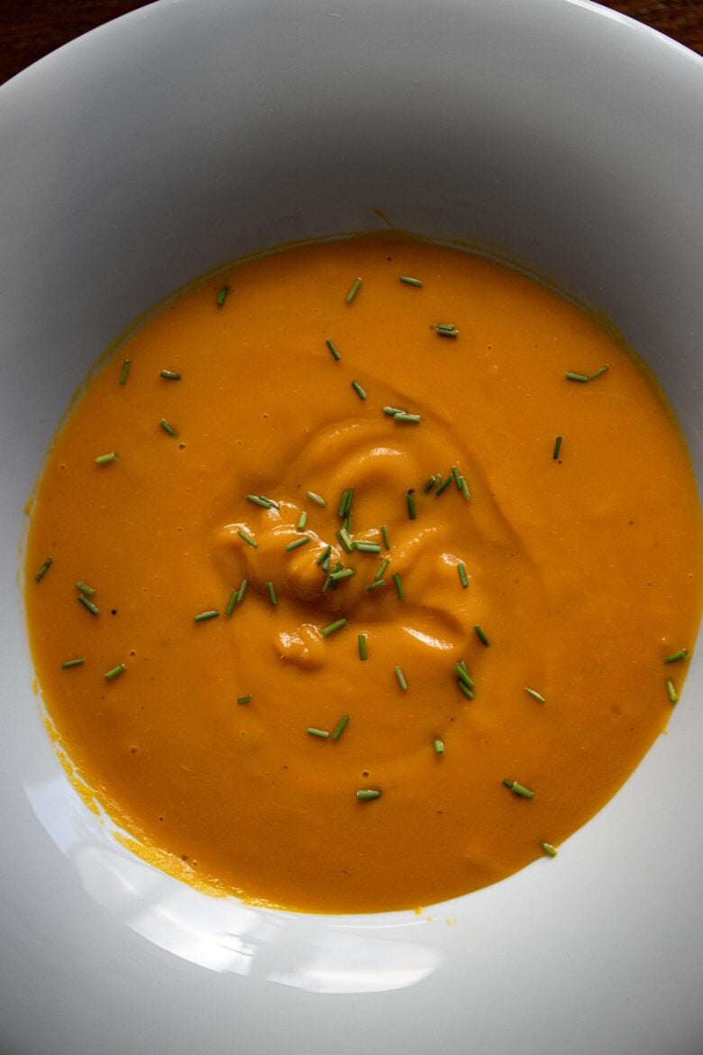 Easy cream of carrot soup close up in a white soup dish