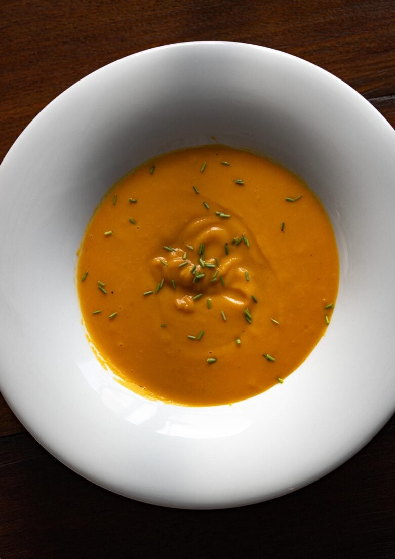 Easy cream of carrot soup in a white dish