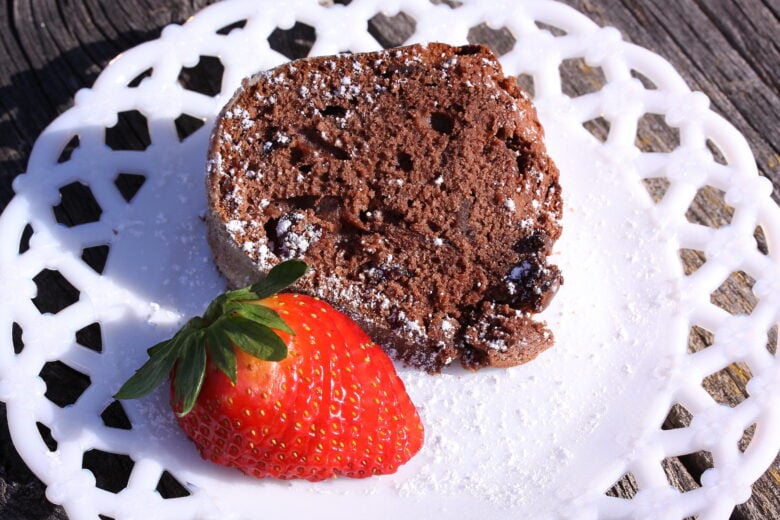 deep chocolate pound cake slice on a white plate