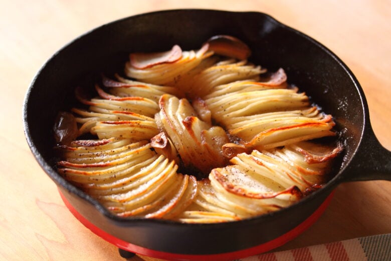 garlic potatoes out of the oven in a black Lodge skillet