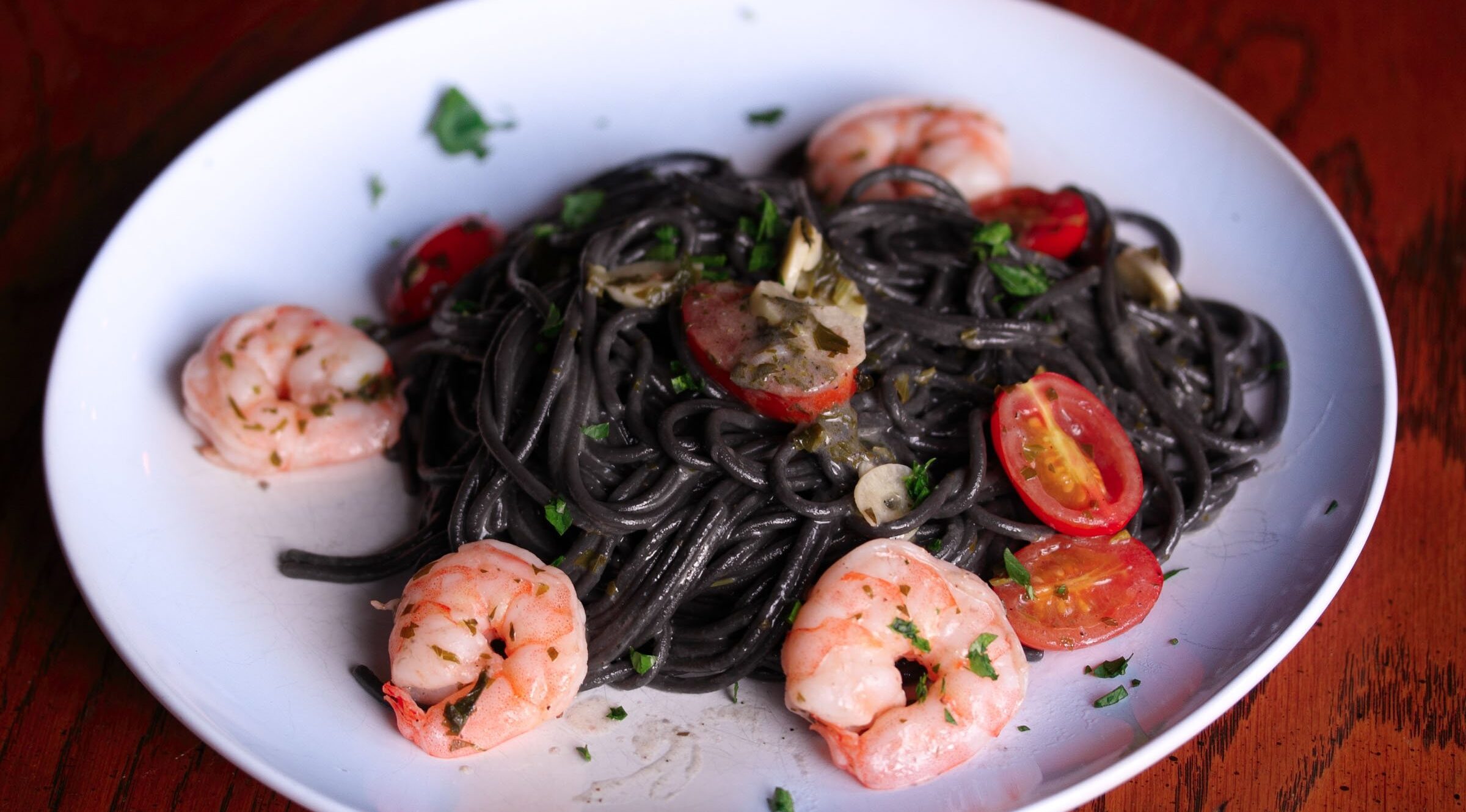 ink pasta with shrimps, tomatoes and garlic