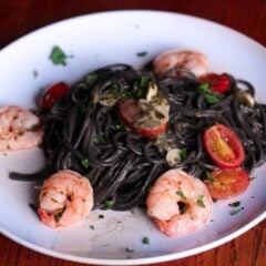 ink pasta with shrimps, tomatoes and garlic