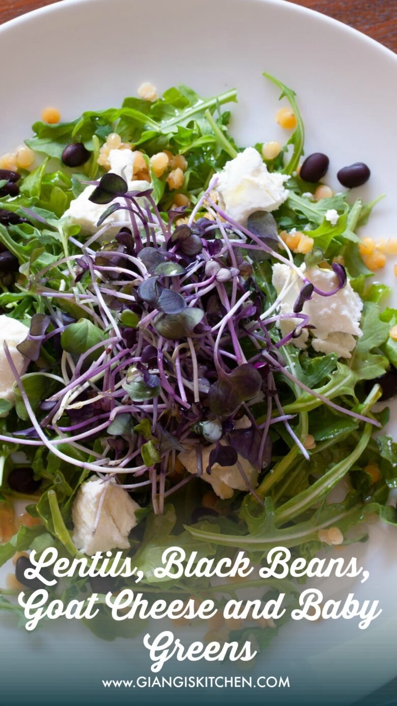 crimson lentils with black beans with aragula salad, goat cheese on a white serving plate