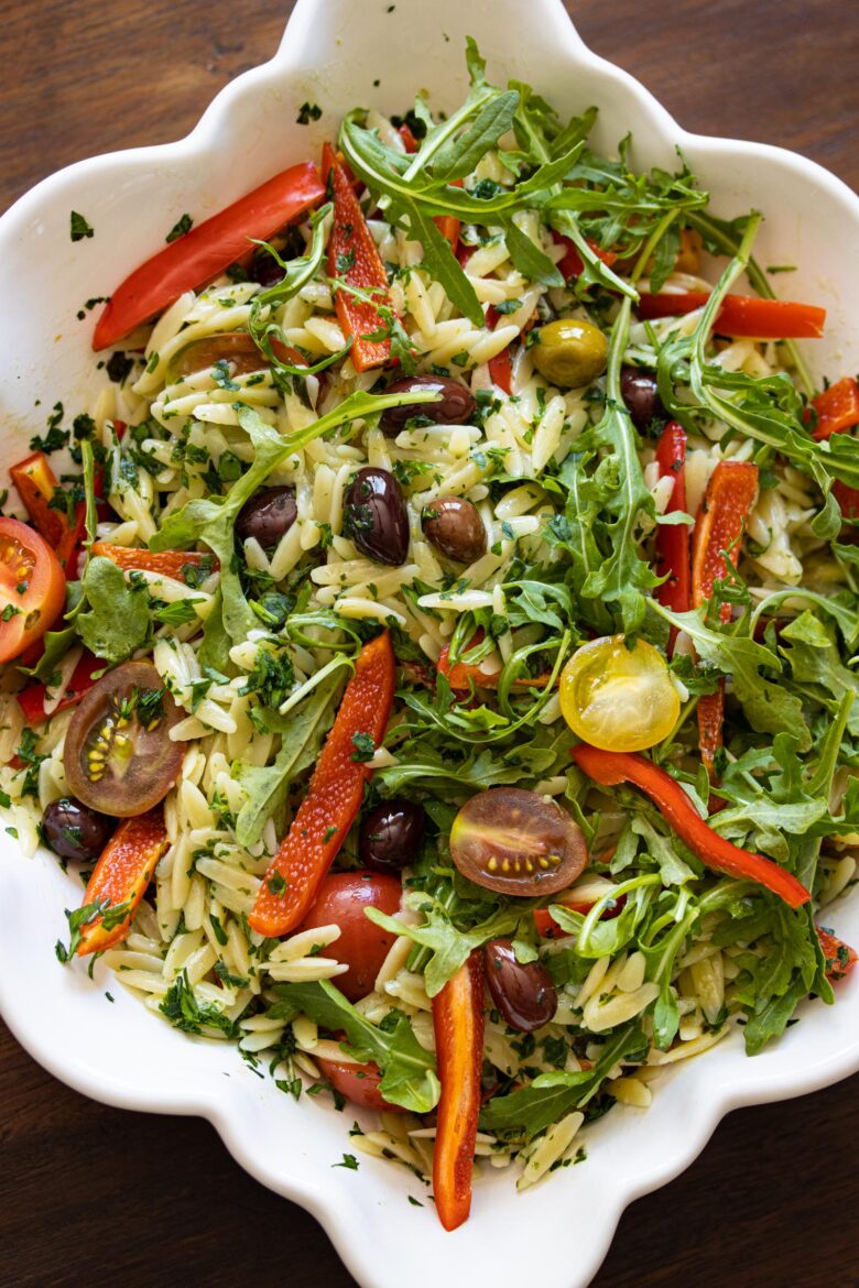 Orzo pasta salad with basil butter, peppers, tomatoes