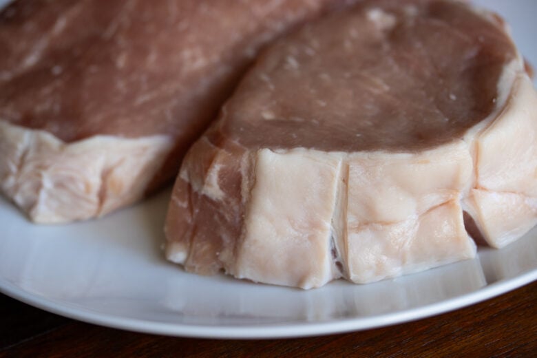 bone in pork chop with fat bard slit