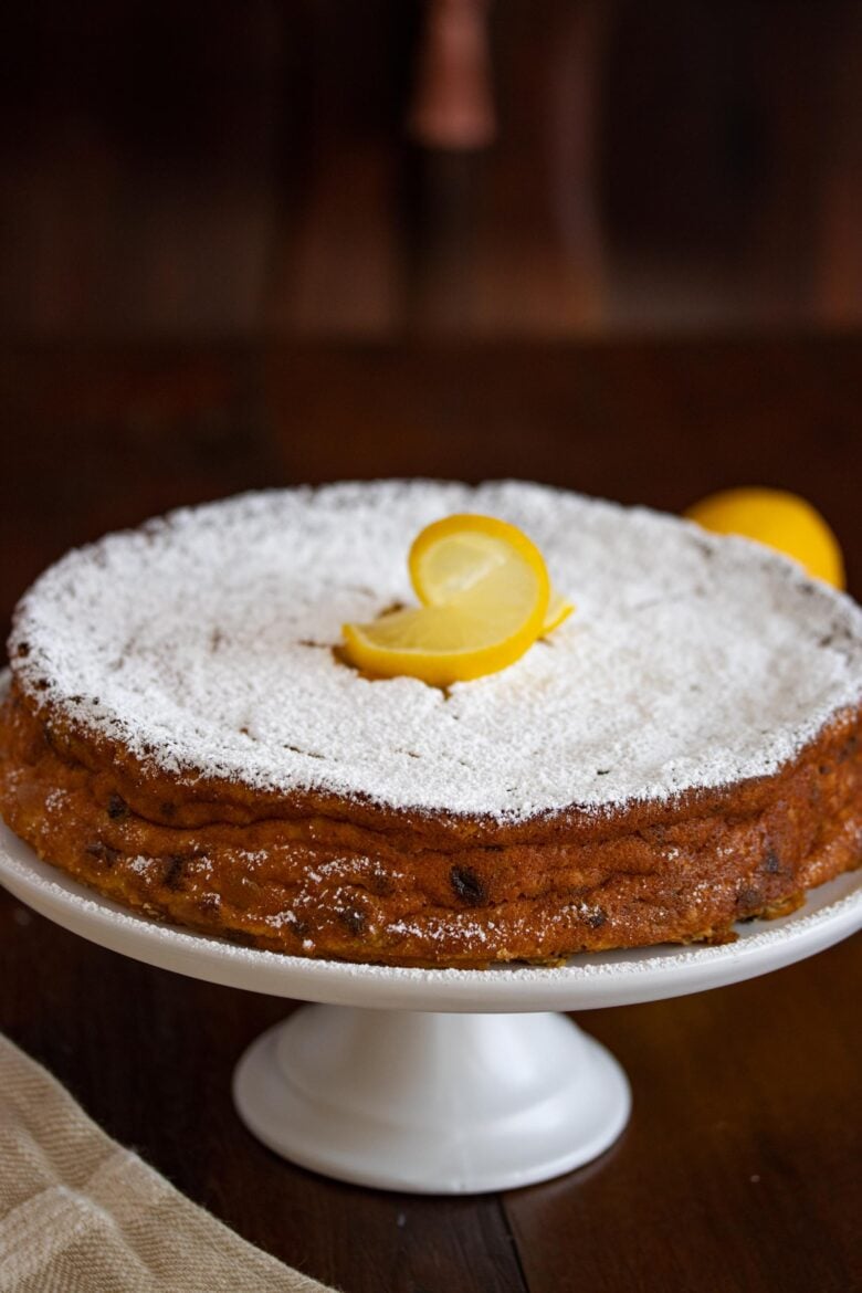 Ricotta Lemon Cake on a white cake stand 