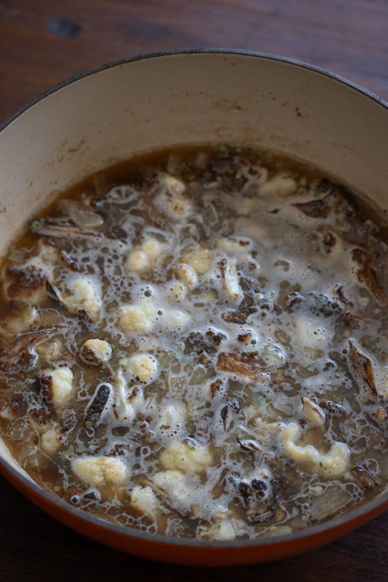 cauliflower in the Dutch oven with chicken stock