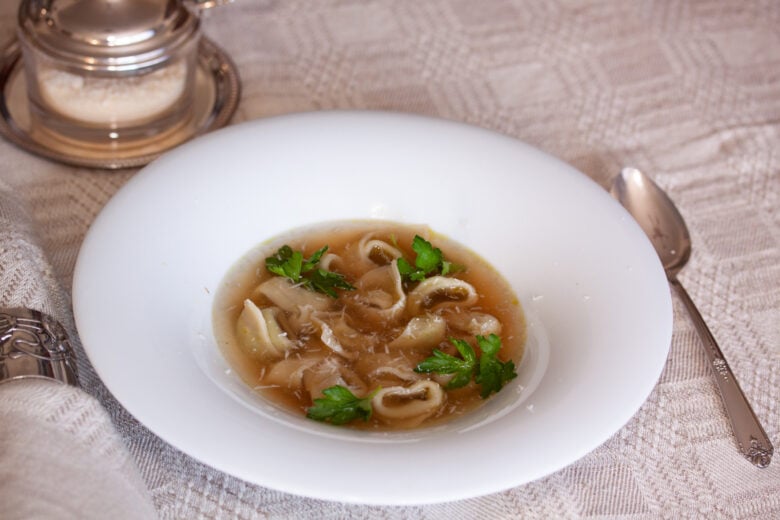 tortellini soup served on a white dish