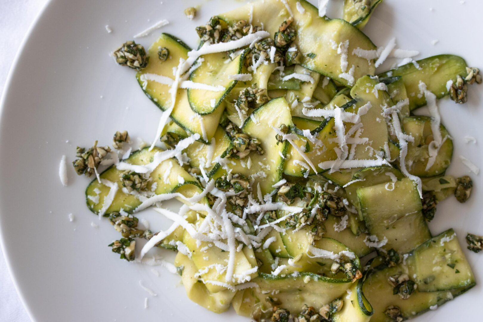 zucchini salad with avocado,  gremolata in a serving plte